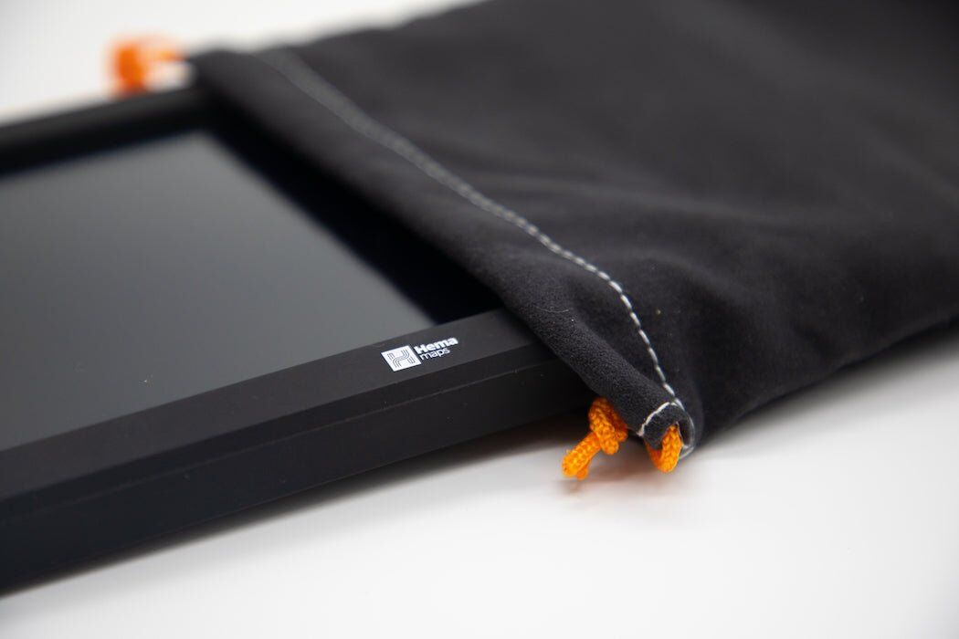 Close-up of a Hema navigator screen half inside the soft fabric pouch