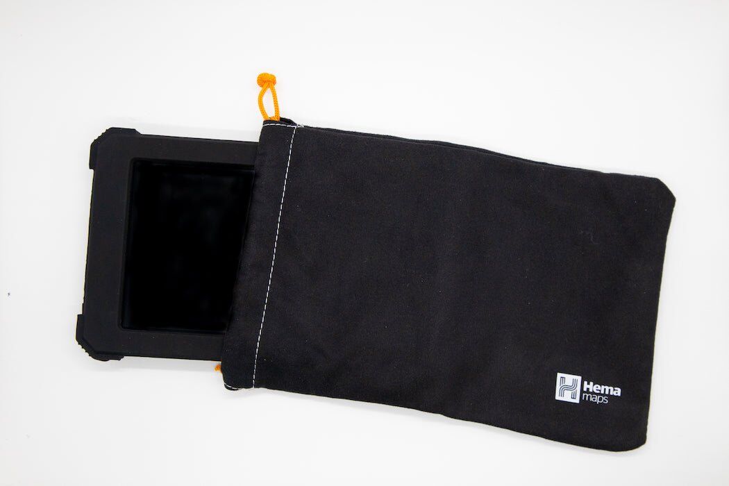 Hema navigator in its rugged case sliding into the black Hema drawstring pouch