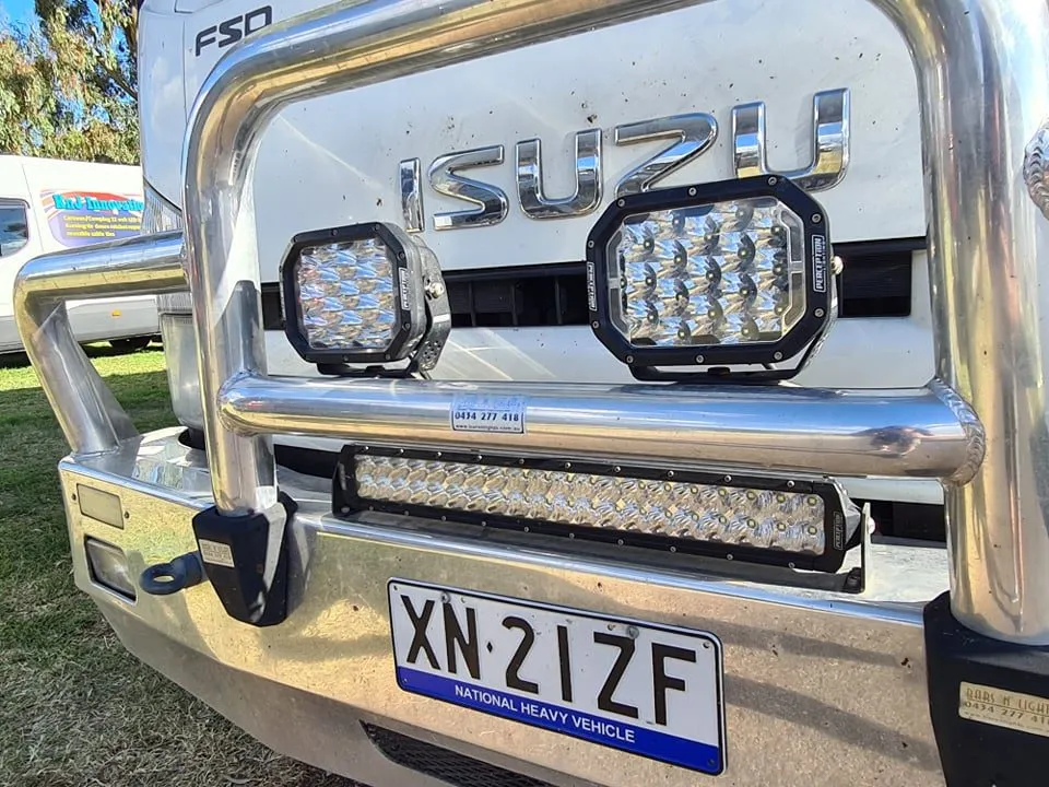 Pair of Apex Quad driving lights on the bull bar of an Isuzu truck