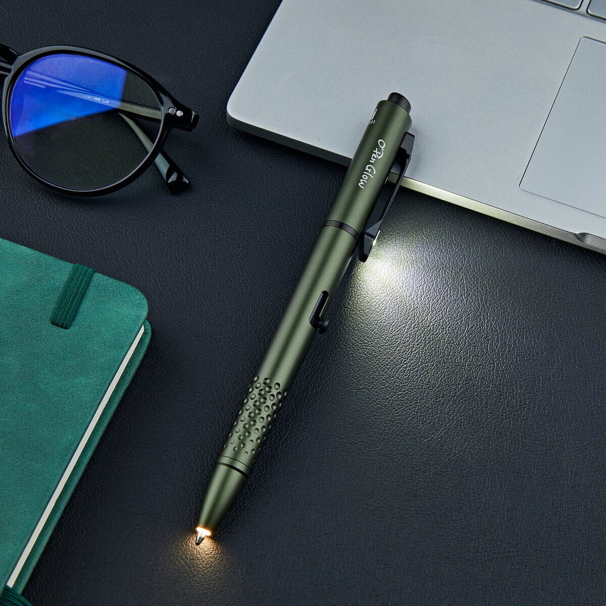 OD Green Olight Open Glow penlight lighting a desk with its clip light and tip light
