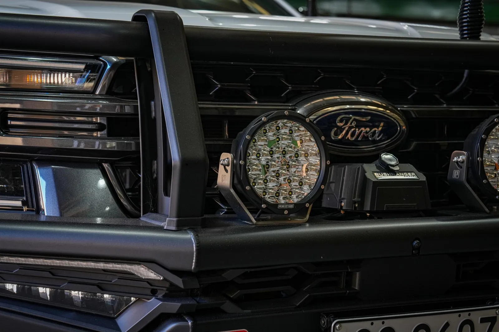 Close-up of an Apex 7 driving light on its stainless bracket