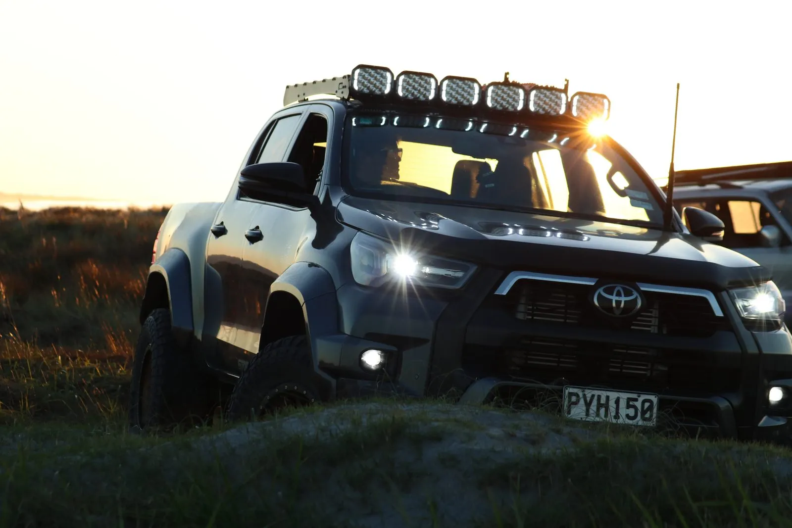 Six Apex Quad lights on a Hilux roof rack with their white DRL strips glowing