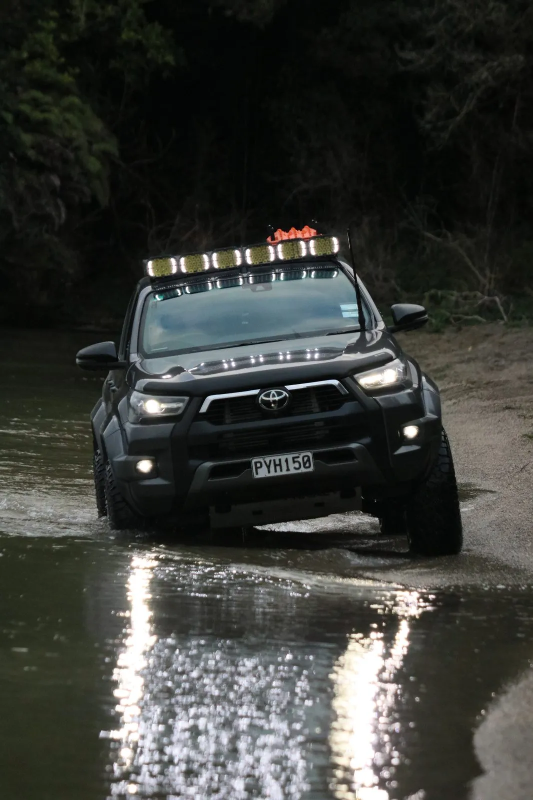 Hilux with Apex Quad lights driving through a river crossing